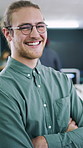 Creative, face or man in office with arms crossed, new job or ambition in advertisement industry. Happy, portrait or branding clerk with confidence, career growth or internship in marketing agency.