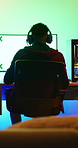 Gaming, computer screen or man with headset in home, virtual competition or playing for entertainment. Digital world, back or person with tech for video game contest, neon lights or online battle