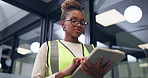 Construction, office and black woman on tablet for online report, building assessment and review. Supervisor, low angle and person on tech for compliance, renovation project and property evaluation