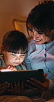 Tablet, mother and kid in bedroom for relax together, bedtime game or learning with parent at night. Tech, happy mom and girl in bed at home to scroll, talking and play on educational app for bonding