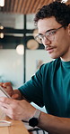 Man, typing and remote work in cafe with tablet, glasses and online research for web design project. Creative, freelance digital designer and person in restaurant with tech, site development or plan.