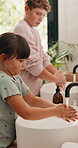 Water, bathroom and children washing hands in home for hygiene, health and wellness with sanitation. Disinfection, basin and kids cleaning skin for dirt, germs or bacteria removal in apartment.