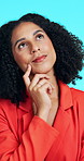 Thinking, business or woman with decision in studio for marketing, creative career or brand identity. Reflection, planning or marketer with idea for campaign development, smile or blue background