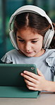 Headphones, tablet and girl for e learning, online education and listening to audio in home. Digital, tech and child with subscription for virtual lesson, development and interaction on streaming app
