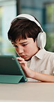 Headphones, tablet and child for e learning, online education and listening to audio in home. Digital, tech and boy with subscription for virtual lesson, development and interaction on streaming app