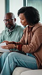 Argue, finance and African couple on sofa with documents for bills, mortgage payment and banking. Marriage, stress and man and woman with paperwork, conflict and worry for debt, budget and savings
