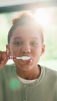 Face, child and brushing teeth for oral hygiene in bathroom, home and washing mouth for fresh breath. Morning routine, cleaning and girl with toothbrush for dental care, wellness and decay prevention