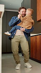 Dad, dancing and son with smile in kitchen with love, bonding and care for connection in house. Happy people, father and child with rhythm, holding hands or excited with laugh at family home