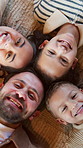 Happy, above and face of family on floor for connection, bonding and relationship on weekend. Home, love and portrait of mom, dad and children with smile for trust, security or support in living room