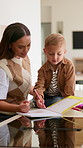 Mom, boy and drawing with book in home with smile, talk or writing with stationery for creativity. People, mother and kid for  bonding with color, pencil and teaching for education at family house