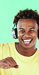 Music, face and man dance in studio, headphones and streaming radio on green background. Excited person, portrait and listening to audio, favorite playlist and hip hop sound for freedom with rhythm