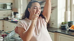 Dancing, woman and singing with spoon in kitchen, meal prep and move with energy on weekend or goofy. Happy person, music and stress free with rhythm, cooking and celebration for success in house