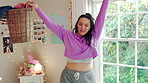 Dancing, music and woman with laundry basket for fun with chores, housework and cleaning on weekend. Home, happy and person with audio, radio and movement for energy with clothes for hygiene routine