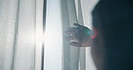Window, curtain and hands of woman in home for wake up, sunrise and fresh air in bedroom. Drapes, lens flare and back of female person by glass for new day with relax and calm in summer at apartment.