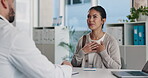 Checkup, doctor and patient talking of heart, chest pain or hypertension advice in medical office. Healthcare, evaluation and cardiology listening to woman for symptoms, questions and explaining
