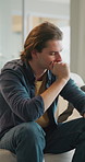 Thinking, student and man on sofa with worry for future decision, college application and regret. Home, frustrated and person with anxiety for results, university rejection and failure for mistake