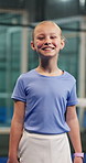 Happy, athlete and face of child for padel practice, match or exercise with fitness hobby. Smile, wellness and portrait of girl kid with pride for tennis game, training or health in sports club.