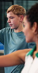 Padel, sports and boy with coach on court for learning to swing, serve and skill for game or practice. Fitness, tennis and trainer with teenager for lesson, exercise or training with racket for match