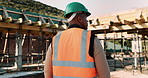 Thinking, construction and black man with helmet for planning, building and site inspection. Civil engineer, outdoor and back of person with reflection for infrastructure, project and repair with ppe