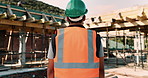 Thinking, construction and back of man with helmet for urban planning, building project and repair. Civil engineer, outdoor and person with reflection, inspection and ppe for safety in infrastructure
