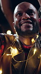 Night, festival or dancing with happy man for concert, outdoor party or fun music celebration. Excited, male person or community jumping with lights in evening for sound or festive event together