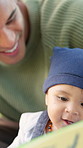 Dad, baby and reading book with smile for bonding together, learning or early childhood development. Happy father, infant boy and storytelling with kids novel for education, knowledge growth or help.