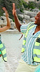 Clean up, high five and volunteers on beach for community, service or sustainability program outdoor. Happy, trash bag and group of people with social responsibility for waste management by ocean.