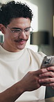 Man, phone and typing at office with smile for notification, contact and glasses at startup company. Person, happy and texting with mobile app, break and social media management at digital agency
