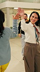 Business, woman and walking in office with high five for greeting, good news and celebration. Smile, person or fist bump with employees, positive energy and team encouragement for night shift success