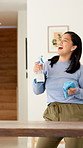 Dance, happy and people with music for cleaning, housework and maintenance in home. Singing, together and woman with person with spray bottle and audio for housekeeping, disinfection and bacteria