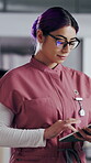 Woman, nurse and tablet in clinic for research, schedule update or healthcare info. Medical attendant, glasses or tech in hospital for telehealth platform, typing digital report or app for efficiency