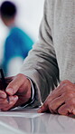 Documents, hands and writing with patient in hospital for appointment, check in or personal details. Information, paperwork and pen with person at counter in clinic for insurance approval or sign up
