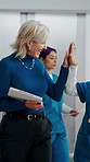 Manager, nurse and high five in hospital with medical internship, clipboard or success for mentorship. Healthcare intern, people and walk in clinic with checklist, celebration or training achievement