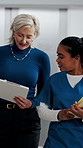 Clipboard, discussion and medical team walk in hospital with mentorship and feedback for internship. Manager, intern nurse and people in clinic with checklist, training plan or advice for healthcare.