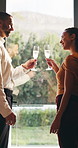 Couple, champagne and toast at window in hotel room for celebration, anniversary and hug with smile. Happy people, partnership and drinks for relationship, achievement and goals at luxury resort