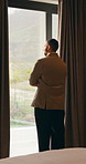Thinking, window and business man in hotel with reflection for work trip, decision and planning. Hospitality, travel and person with view for thoughtful, wondering and ideas for convention at resort