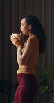 Happy woman, thinking and coffee in home at window, reflection and blow drink in morning. Person, mindset and perspective with beverage, tea cup and smile for nostalgia with daydream at apartment