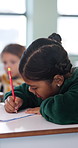 Education, child and writing with book in class, development and knowledge for growth at school. Notes, girl and student learning in lesson, assignment information and studying with assessment