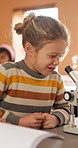 Learning, science and kid with microscope in class for development, knowledge or study at school. Child, microbiology and education with equipment in lab lesson, students and growth experiment