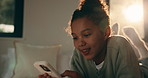 Relax, typing or phone with happy girl on bed for social media, communication or connection in home. Child, kid or teenager lying with smile, lens flare or mobile smartphone for online chatting app