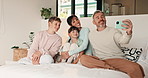 Selfie, smile and relax with family in bedroom for social media post, memory and bonding. Love, mobile photography and picture with parents and children in home for connection, happy and care