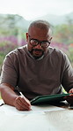 Black man, tablet and writing for taxes in home with review, paperwork and glasses for bills in morning. Person, tech and documents with budget, fintech or app with asset management at apartment