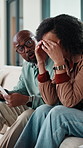 Stress, finance and African couple on sofa with documents for bills, mortgage payment and mistake. Marriage, home and man and woman with paperwork, conflict and worry for debt, budget and savings