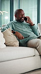 Black man, phone call and relax on couch with smile, chat and glasses with story in living room. Mature African person, happy and joke with mobile network, communication or laugh with gossip at house