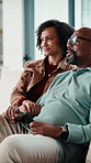 Relax, happy and couple in home watching tv for movie, series or film together on weekend. Smile, bonding and mature man with woman for streaming show with online subscription in living room at house