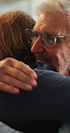 Senior father, son and hug in home for support, love and bonding together on sofa. Relax, happy men and elderly person with embrace for respect, care or comfort on weekend in living room with smile