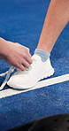 Padel, help and person tie shoes in court for training, exercise and prepare for tournament. Sports, tennis and hands of people with shoelace ready for game, practice and fitness for competition