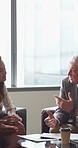 Mature, businessman and lawyer with clients for discussion, legal agreement or meeting in office. Man, attorney or explaining policy with documents or paperwork to couple for advice, deal or contract