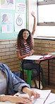 Education, question and hands raised with girl in classroom for learning, discussion and knowledge. Laugh, student and teenager with smile and assessment at school for why, scholarship and answer