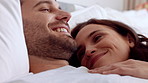 Couple, cuddle and relax on bed in home, love and affection for partner and commitment for marriage. Happy people, resting and embrace with spouse in bedroom, man and bonding with woman or romance